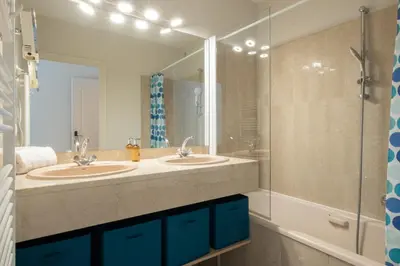 a bathroom with two sinks and a shower at 3P Garden-Level Apartment in a Residence with Pool Close to the Center in Cannes