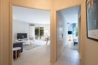 a hallway with a door leading to a living room at 3P Garden-Level Apartment in a Residence with Pool Close to the Center in Cannes