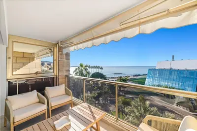 a balcony with chairs and a view of the ocean at REF 2030 - Cannes Croisette - Sea view apartment for rent in Cannes