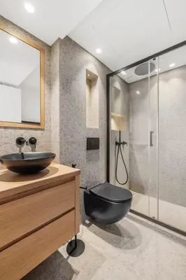 a bathroom with a black toilet and a glass shower at REF 2030 - Cannes Croisette - Sea view apartment for rent in Cannes