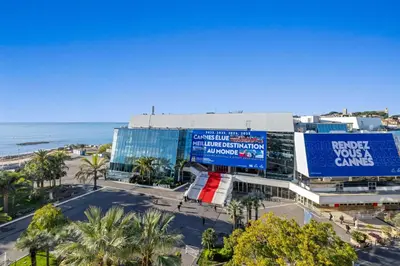 a view of a building with a beach and the ocean at REF 2030 - Cannes Croisette - Sea view apartment for rent in Cannes