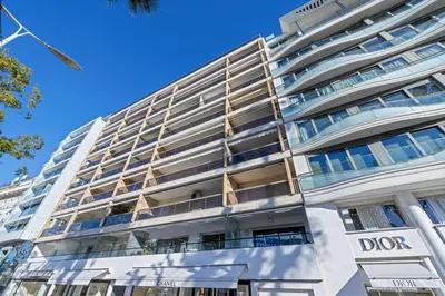 a large white building with a dops sign on it at REF 2030 - Cannes Croisette - Sea view apartment for rent in Cannes