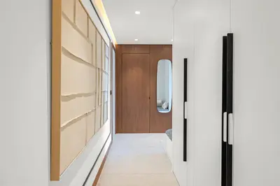 a hallway with white walls and wooden doors at REF 2030 - Cannes Croisette - Sea view apartment for rent in Cannes