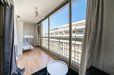 a room with a balcony with a view of a building at Spacious 1-bedroom apartment in the heart of Cannes in Cannes
