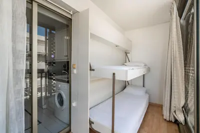 a small bathroom with a washing machine and a laundry room at Spacious 1-bedroom apartment in the heart of Cannes in Cannes