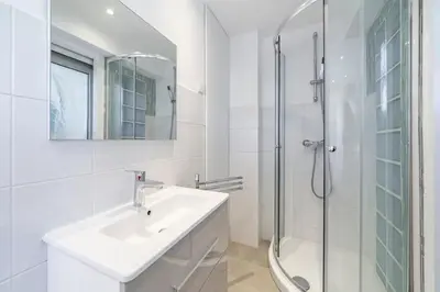 a white bathroom with a sink and a shower at Brand new 2 bedrooms heart of Cannes in Cannes
