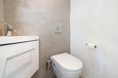 a white bathroom with a toilet and a sink at Brand new 2 bedrooms heart of Cannes in Cannes
