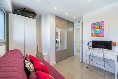 a living room with a purple couch and a tv at Brand new 2 bedrooms heart of Cannes in Cannes