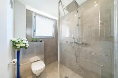 a bathroom with a toilet and a glass shower at Brand new 2 bedrooms heart of Cannes in Cannes