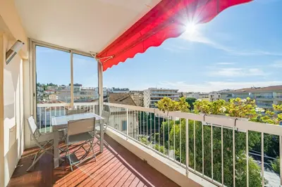 a balcony with a desk and a view of the city at Brand new 2 bedrooms heart of Cannes in Cannes