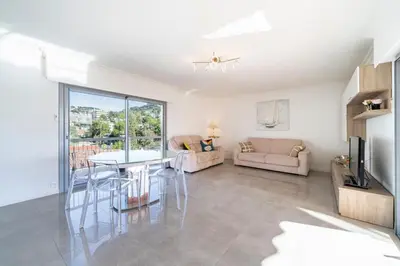 a living room with a table and a couch at Brand new 2 bedrooms heart of Cannes in Cannes