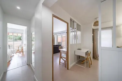 a room with a mirror and a table and a desk at Charmant appartement 2 pièces in Cannes