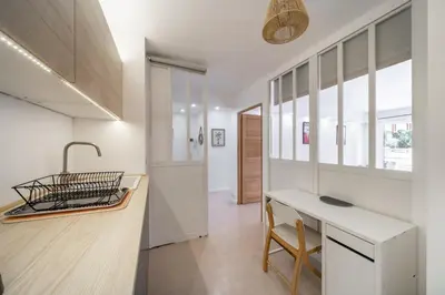 a kitchen with a counter and a sink and a table at Charmant appartement 2 pièces in Cannes