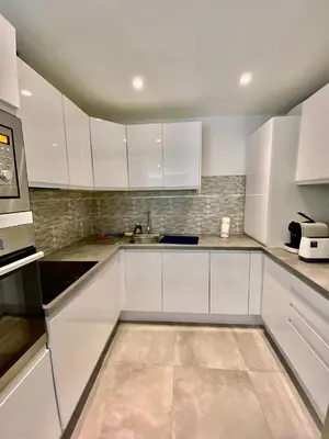 a white kitchen with white cabinets and appliances at Cannes one bedroom apartment - 8D1 in Cannes