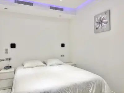 a white bedroom with a bed with white sheets at Cannes one bedroom apartment - 8D1 in Cannes