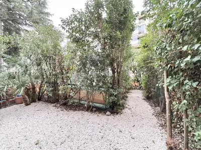 a garden with trees and a building in the background at Cannes one bedroom apartment - 8D1 in Cannes