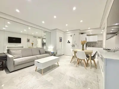 a living room and kitchen with a couch and a table at Cannes one bedroom apartment - 8D1 in Cannes