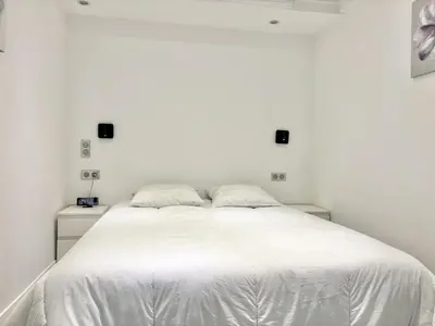 a bedroom with a white bed with two pillows at Cannes one bedroom apartment - 8D1 in Cannes