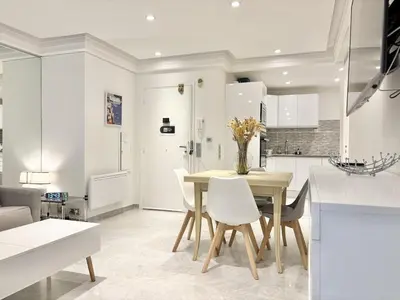 a kitchen and dining room with a table and chairs at Cannes one bedroom apartment - 8D1 in Cannes