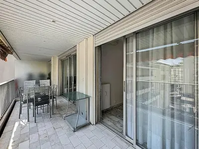 a balcony with a table and chairs on a patio at 47m2 - climatisation, carré d'or in Cannes