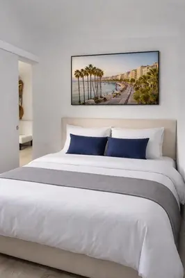 a bedroom with a white bed and a window at Cannes Centre Appartement Rénové avec Terrasse au Calme Plages & Croisette à Pied in Cannes