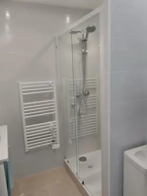 a kitchen with white cabinets and a sink at Cannes Centre Appartement Rénové avec Terrasse au Calme Plages & Croisette à Pied in Cannes