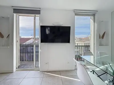 a table on a balcony with a coffee maker on it at Vue mer 50 m plage et Croisette Cannes centre in Cannes