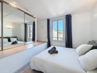 a white bathroom with a toilet and a sink at Vue mer 50 m plage et Croisette Cannes centre in Cannes