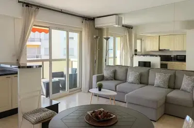 a living room with a couch and a table at Appartement rue D'antibes in Cannes