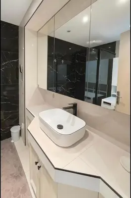 a white bathroom with a sink and a mirror at Appartement rue D'antibes in Cannes
