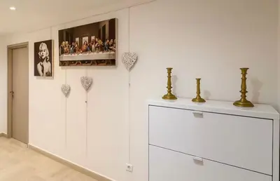 a room with white cabinets and a shelf with photos at Appartement rue D'antibes in Cannes