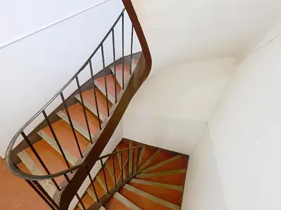 a spiral staircase in a building with a white ceiling at Cosy & modern 1 Bedroom Forville old town 207 in Cannes