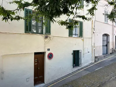 a white building with green windows and a door at Cosy & modern 1 Bedroom Forville old town 207 in Cannes