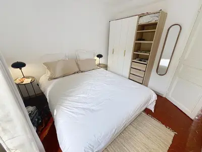 a small bedroom with a white bed and a closet at Cosy & modern 1 Bedroom Forville old town 207 in Cannes
