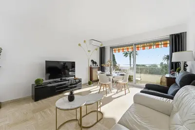 a living room with a couch and a table at La Rose des Vents - Cannes in Cannes