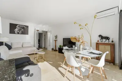 a living room with a table and a couch at La Rose des Vents - Cannes in Cannes