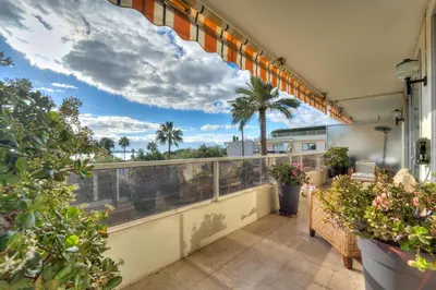 a balcony with plants and a view of the ocean at La Rose des Vents - Cannes in Cannes