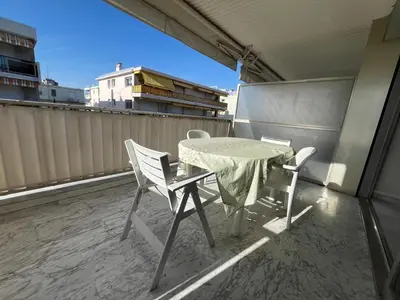 a table and two chairs on a balcony at Riva in Cannes
