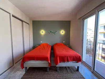 a bedroom with two beds with red blankets at Riva in Cannes