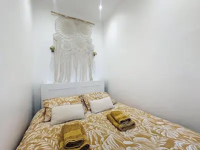 a bedroom with a bed with two pillows on it at 42 m2 - Close to Palais des Festivals and beaches in Cannes