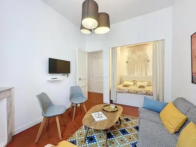 a living room with a couch and a tv at 42 m2 - Close to Palais des Festivals and beaches in Cannes