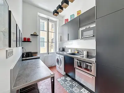 a kitchen with a sink and a stove top oven at 42 m2 - Close to Palais des Festivals and beaches in Cannes