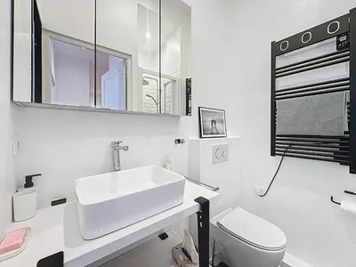 a white bathroom with a sink and a toilet at 42 m2 - Close to Palais des Festivals and beaches in Cannes