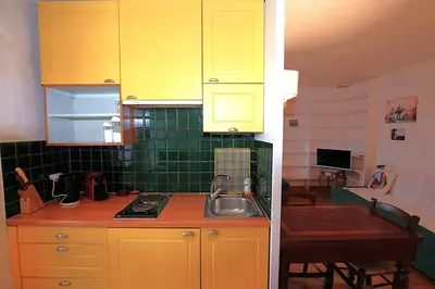 a kitchen with yellow cabinets and a sink at Cannes Central Hub - Walk to Palais & Beach in Cannes