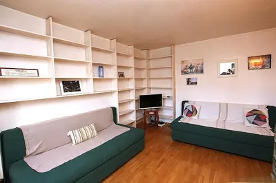 a living room with a couch and a television at Cannes Central Hub - Walk to Palais & Beach in Cannes