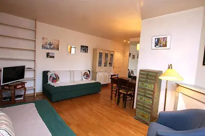 a living room with a couch and a table at Cannes Central Hub - Walk to Palais & Beach in Cannes