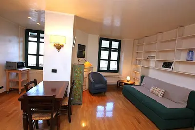 a living room with a couch and a table at Cannes Central Hub - Walk to Palais & Beach in Cannes