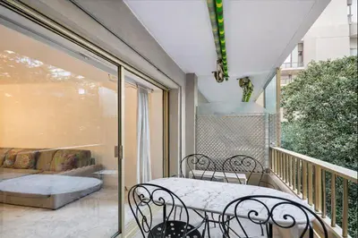 a balcony with a table and chairs on a balcony at Branly in Cannes