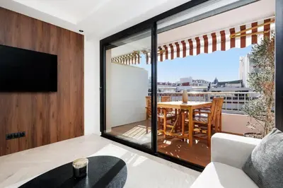 a living room with a table and a large window at Quartier Marriott - Superbe 3 pieces in Cannes