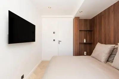 a bedroom with a bed with a television on the wall at Quartier Marriott - Superbe 3 pieces in Cannes